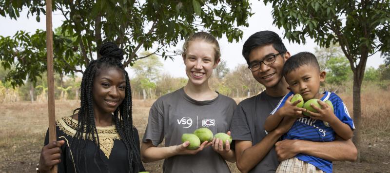 ICS volunteers Tania, Luna & Keira pick mangos with the children in their host home garden